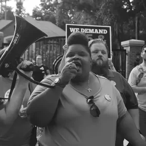 folks at a rally with a megaphone